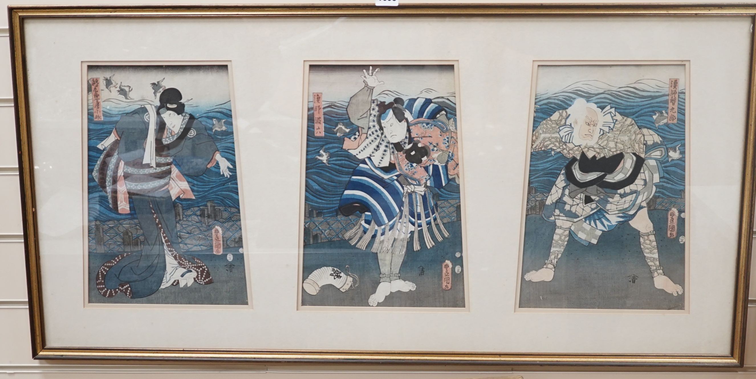 Kunisada, triptych of Japanese woodblock prints, Actors on stage beside the sea, each 35 x 24cm, framed as one